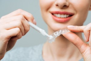 a woman setting up her teeth whitening