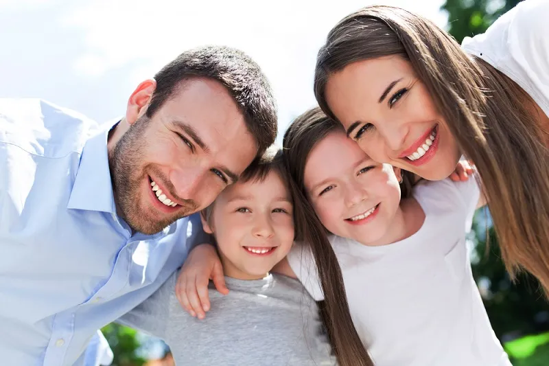 a happy family with healthy teeth